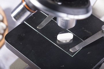 White Pills on Microscope