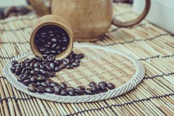 Coffee beans and coffee cup set on bamboo wooden background.Phot