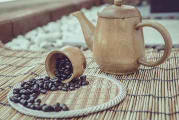 Coffee beans and coffee cup set on bamboo wooden background.Phot