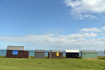 Fototapeta na wymiar Beach huts at Portland Bill on Dorset coast