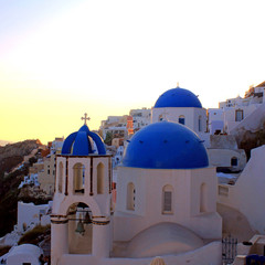 Sunset view with orthodox church,Oia, Santorini island, Greece