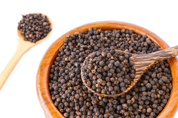 black pepper on wooden spoon with wooden plate isolated on white background.