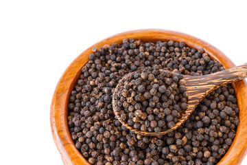 black pepper on wooden spoon with wooden plate isolated on white background.