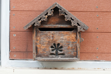 Wooden mail box on the wall.