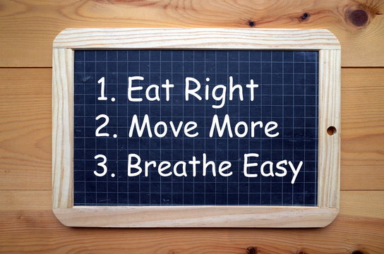 Health and Fitness advice to Eat Right, Move More and Breathe Easy in white text on a slate blackboard