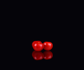 fresh tomatoes on a black background