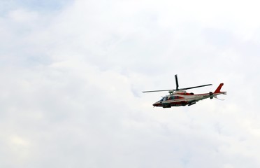 Fototapeta na wymiar helicopter of fireman flies in the sky