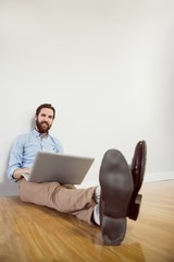 Handsome hipster using his laptop