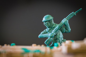 Closeup of action mini toy soldier on black background