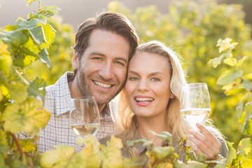 Young happy couple holding glasses of wine