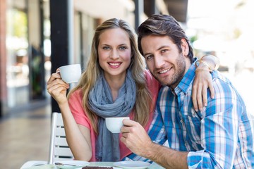 Cute couple having coffee together