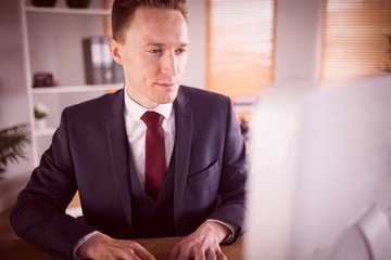 Stylish businessman working at his desk