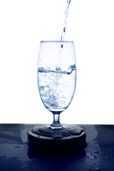 Water is poured into a glass