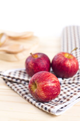 Three fresh apples on wooden background