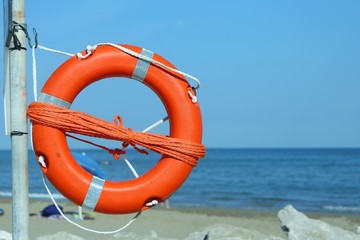 Orange lifebuoy with rope to rescue swimmers 