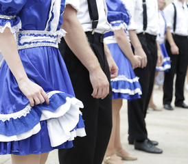 Lateral view of a folk group from the United States,dressed in one of their traditional costumes, ready to dance