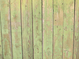 Fragment of a green fence from wooden planks