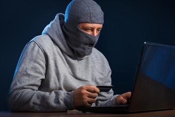 Cyber criminal hacking into a computer. Stealing personal information