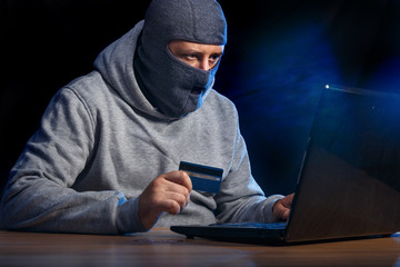 Cyber criminal hacking into a computer. Stealing a bank account