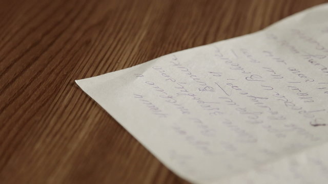 Old personal russian handwritten letter on wooden table close-up
