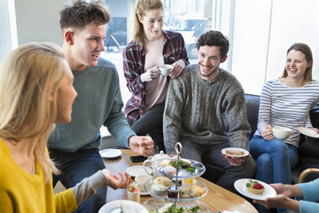 Friends having afternoon tea in a cafe