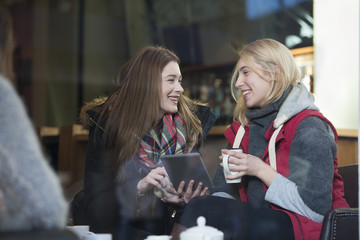 Women in a cafe with a digital tablet