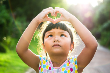 children look pass hand heart