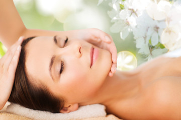Obraz na płótnie Canvas beautiful woman in spa salon having facial massage