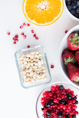 close up of fruits and berries in bowls on table