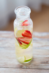 close up of fruit water in glass bottle