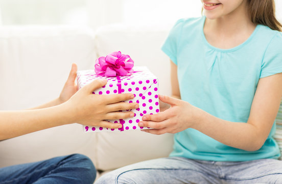 close up of girls with birthday present at home
