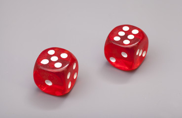 Red dices on grey background