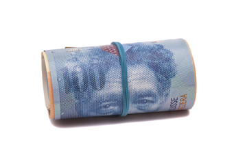 Fototapeta na wymiar Swiss francs in a roll on white background