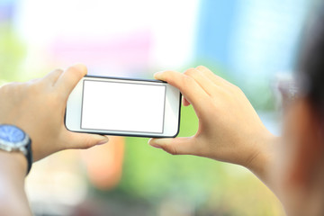 closeup of young woman skateboarder use smart phone in city