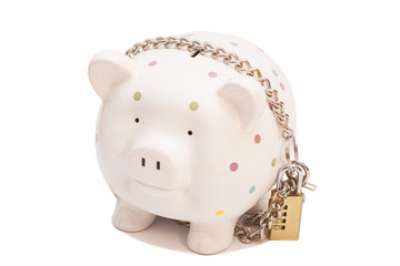 Piggy bank padlocked with chains and padlock on white background