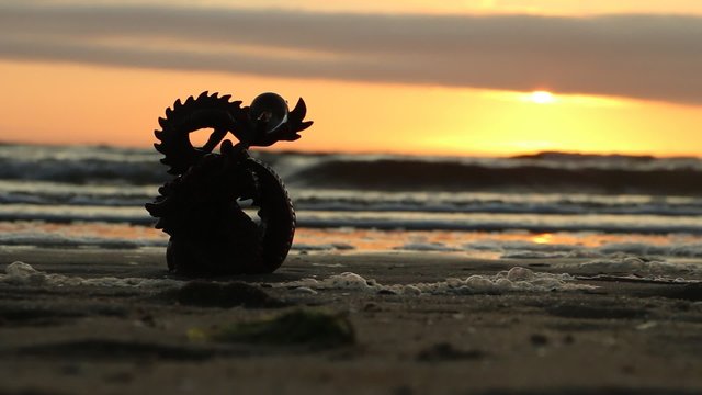 Dragon with pearl, sunset