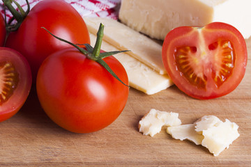 Tomatoes and cheese on chopping board