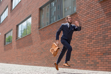 young businessman running in a city street
