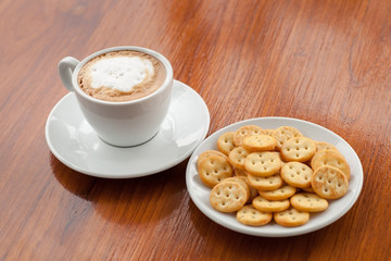 coffee on wood background and biscuits