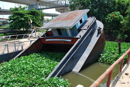 Half sunken tugboat