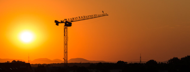 Tower crane in the sunset