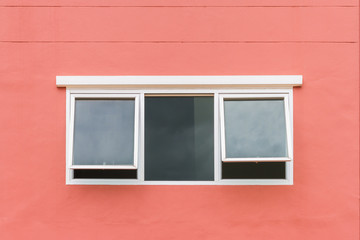Glass window on the orange wall