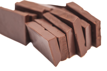 Broken milk chocolate bar isolated on white background