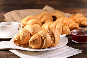 Delicious croissants on plate on table close-up