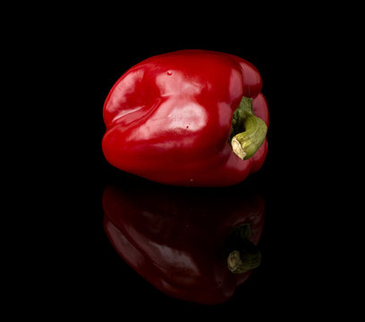 Sweet Red Pepper On A Black Mirror Surface