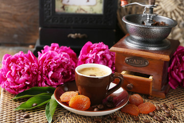 Obraz na płótnie Canvas Composition with, coffee grinder, cup of coffee and peony flowers on wooden background