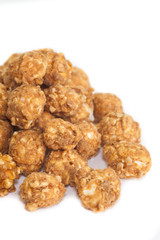 Almond and caramal popcorn on white background