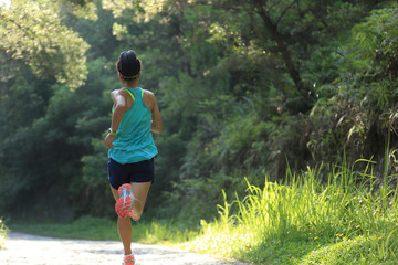 Obraz na płótnie Canvas woman runner running on forest trail. 