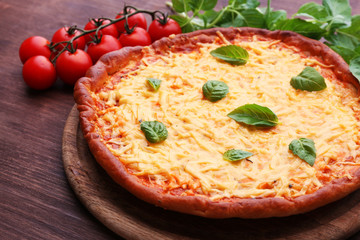 Cheese pizza with cherry tomatoes on table close up