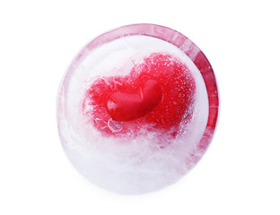 Red heart in ice cube isolated on white